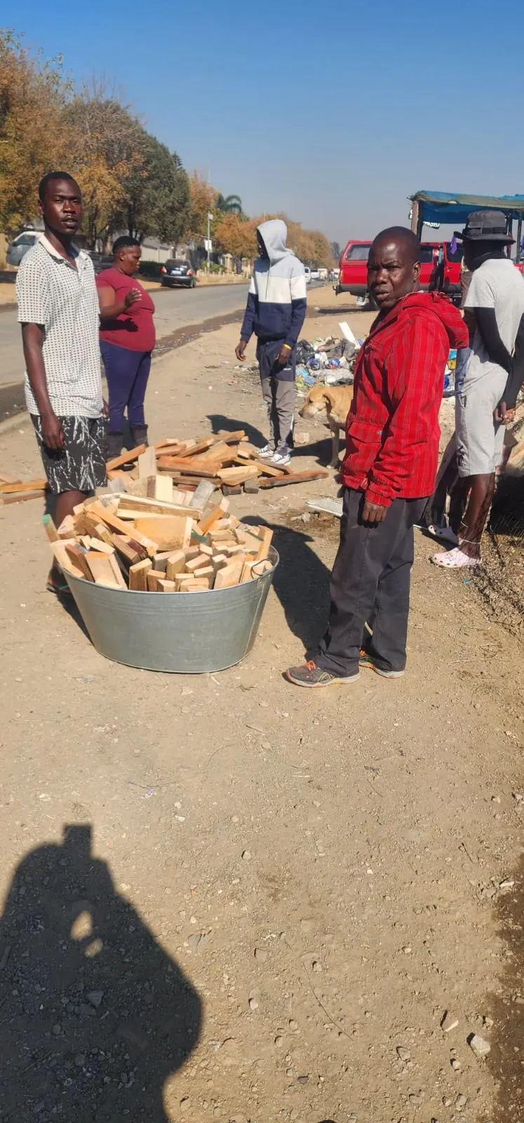 A resident salvaging belongings after a settlement fire