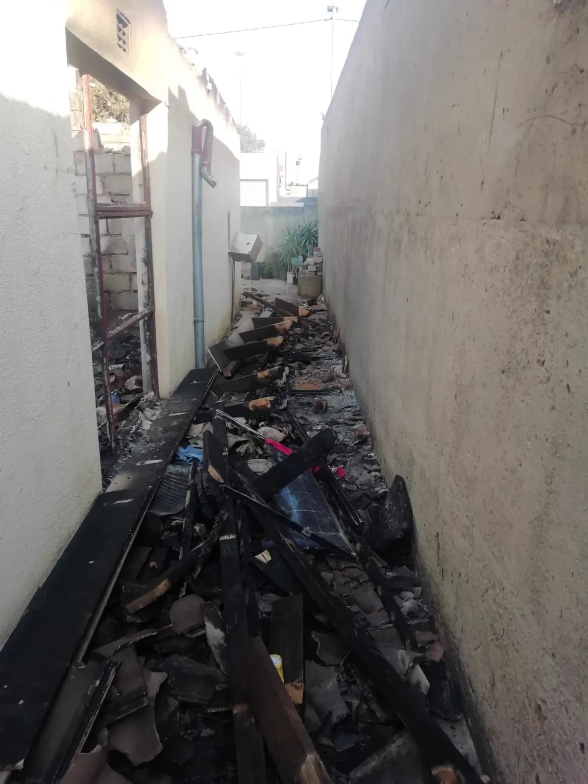 A burnt kitchen area with an open window