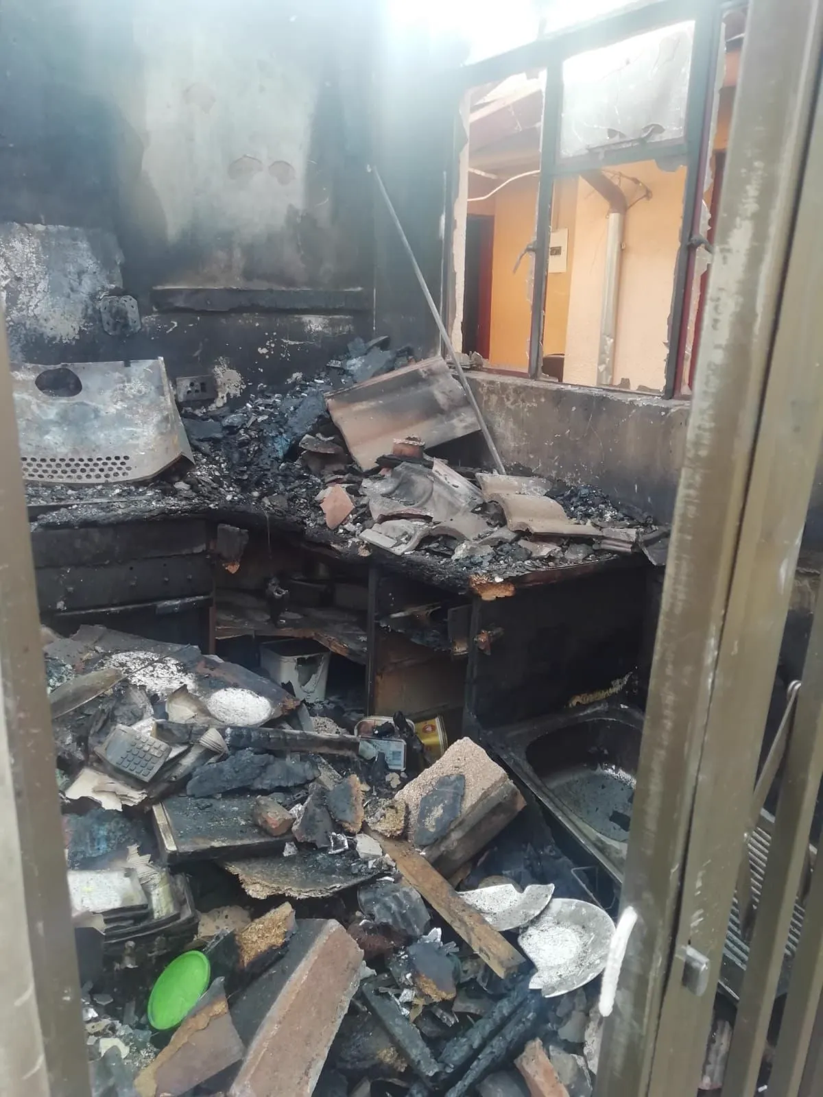 A burnt security gate and doorway