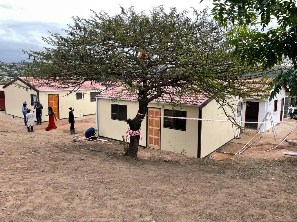 Residents outside newly completed modular homes