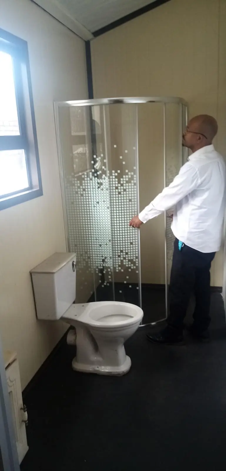 Bathroom fitted inside a UDRS unit, with toilet and shower installed
