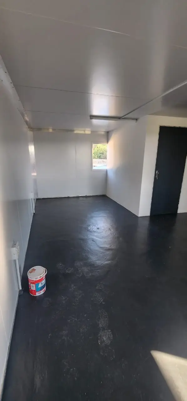 Interior of a UDRS unit showing the screeded floor and a window