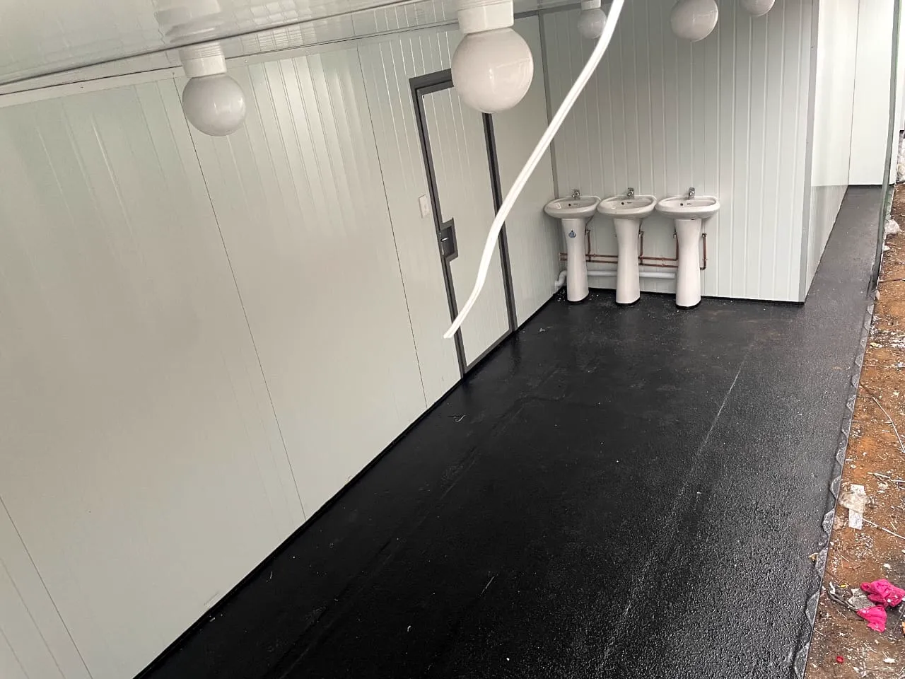 Wash basins inside a converted shipping-container ablution block