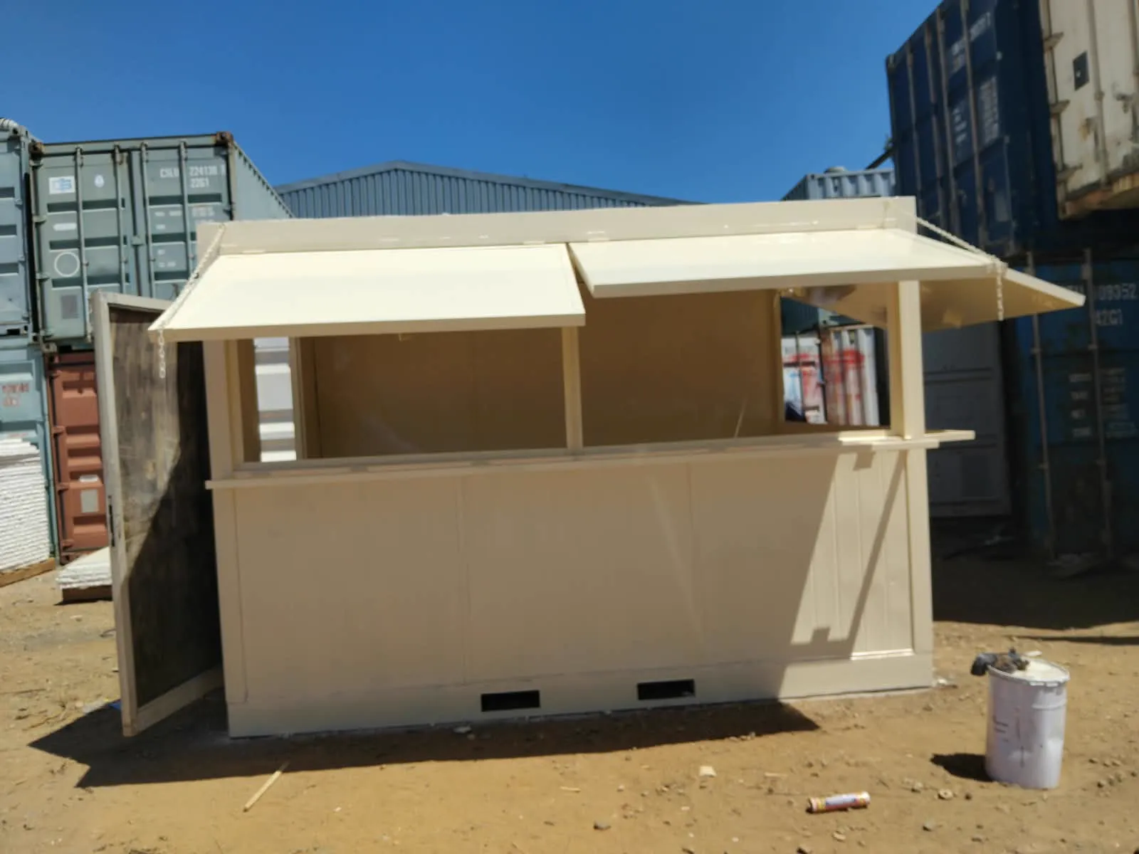 A shipping-container kiosk with serving hatches