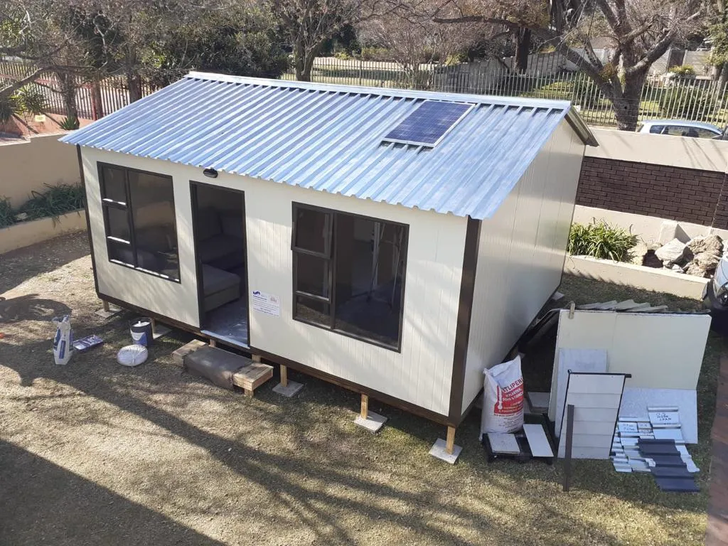 A completed modular home with roof and solar panel