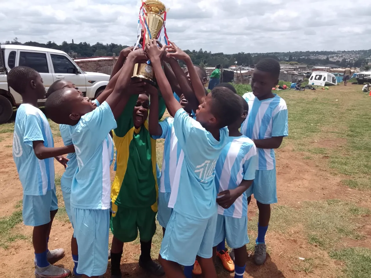 Team hoisting the championship cup together