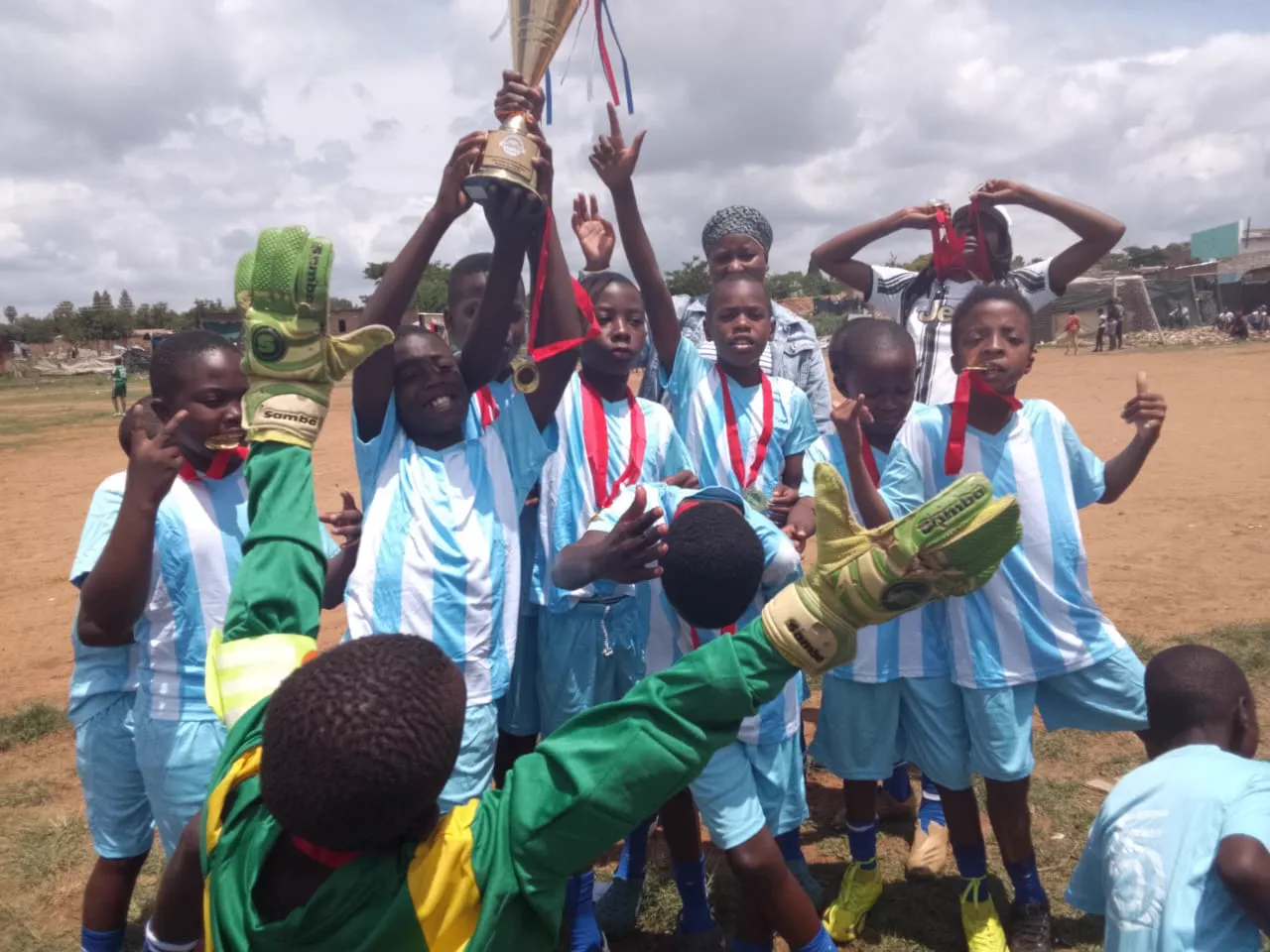 Players celebrating with medals and the trophy
